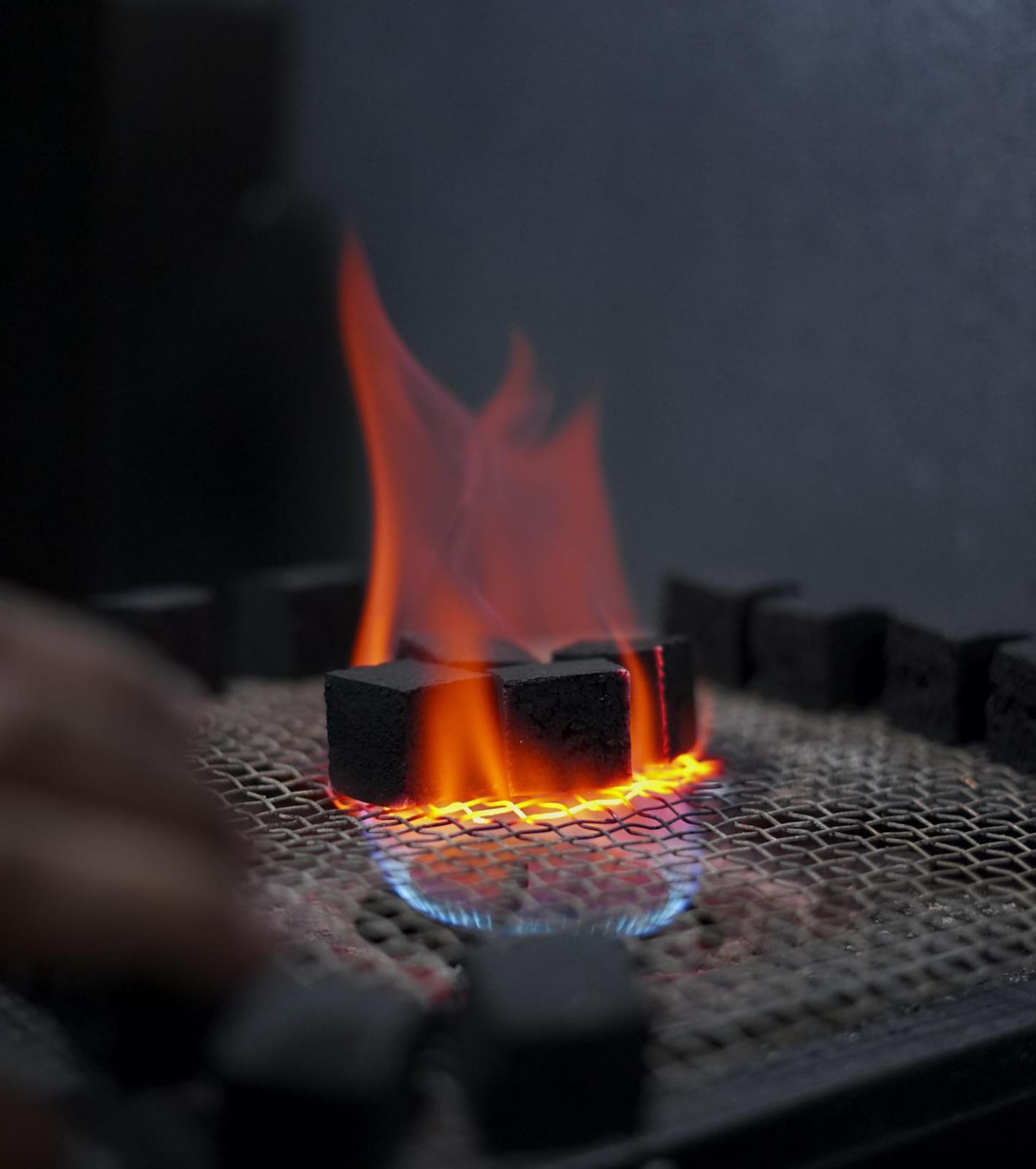 COCOPREM coconut charcoal briquettes undergoing ignition and burning quality control